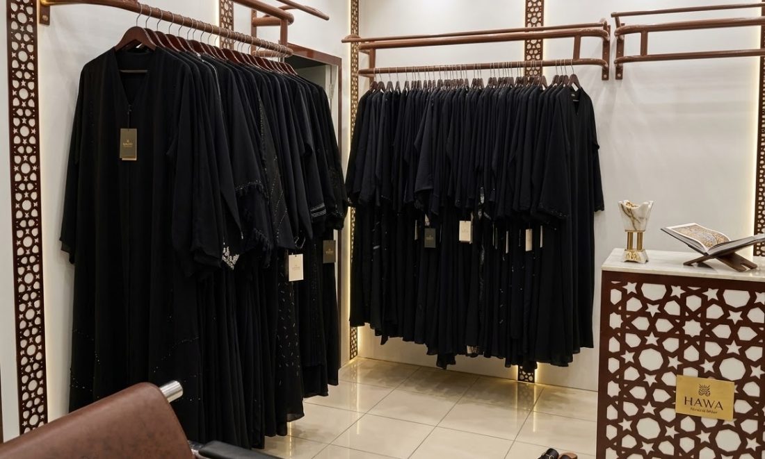 Black abayas on rails inside the boutique