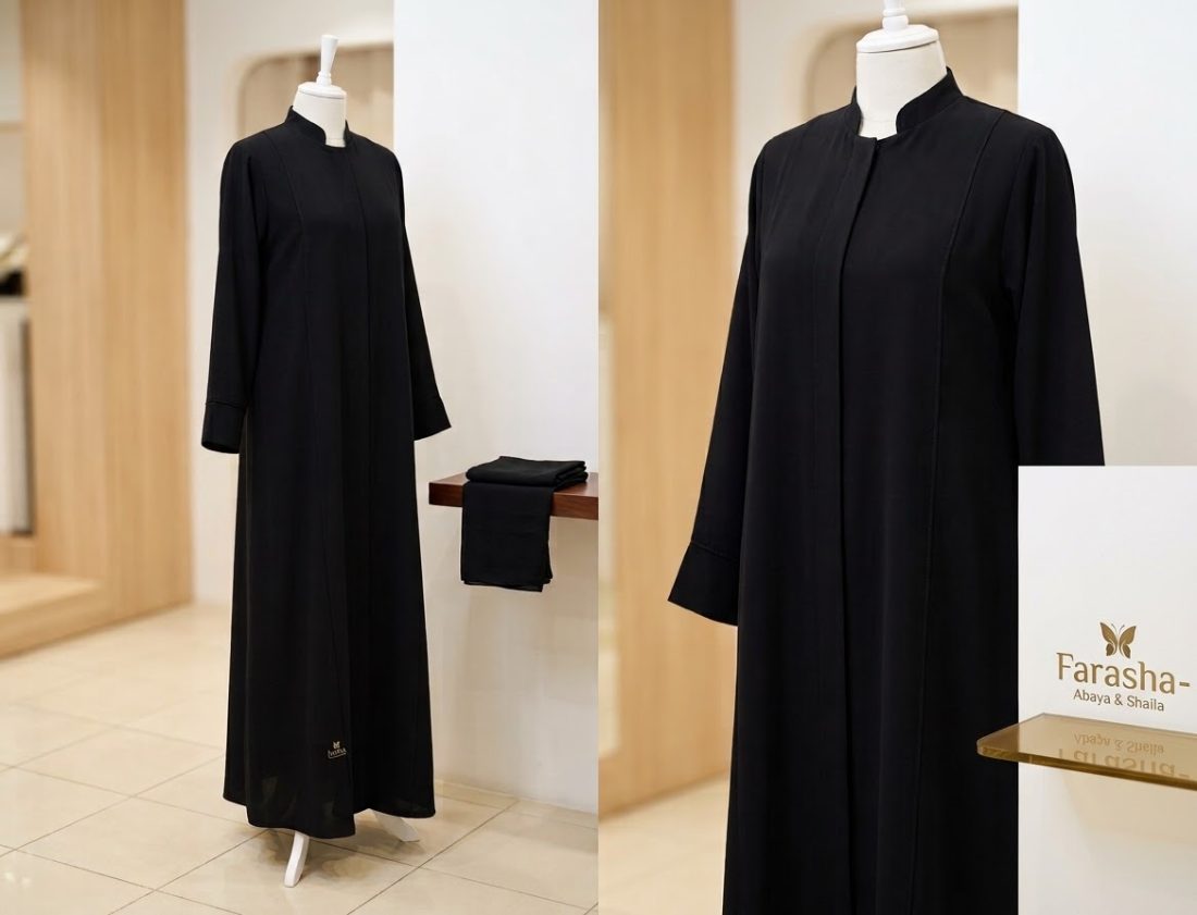 Black closed abaya with mandarin collar, displayed in the boutique